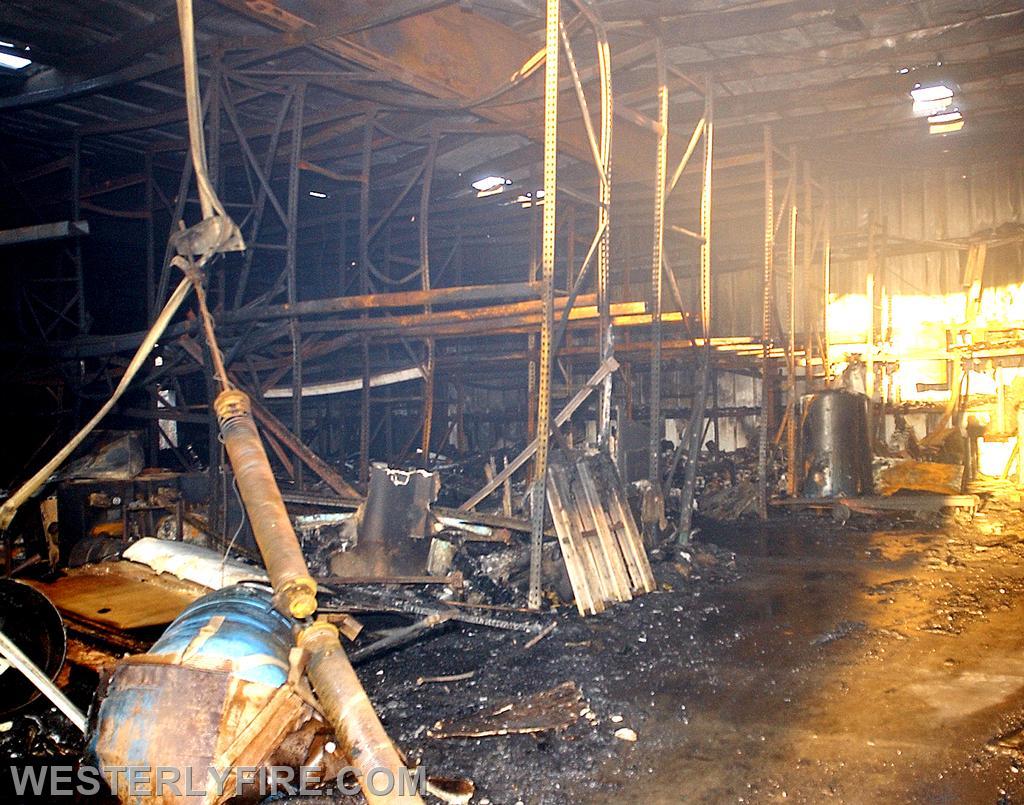 Box 1313-February 4, 2004-The interior of the warehouse the morning after. Steel shelving is bent ad twisted from the heat generated by the fire.