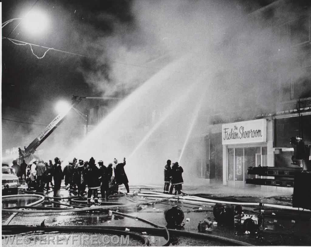 Box 3111-March 14, 1975-Smoke obscures the front of the Potter-Langworthy Building. Pawcatuck's ladder truck protecting the Barber Memorial Building in the background.

