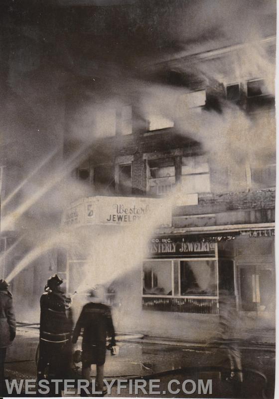 Box 3111-March 14, 1975-Firefighters train hose streams as the fire on the  second and third floors intensifies. 