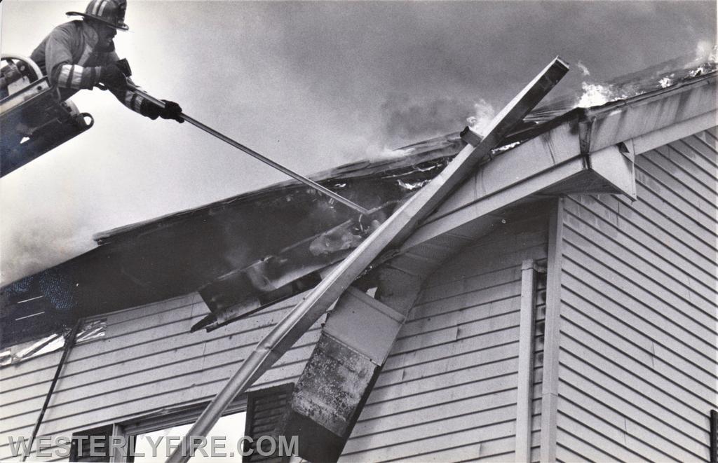 Boxes 4121 and 4115-May 9,1986-Firefighter Mike Gomes works to remove soffits on the B side after Ladder 1 was repositioned