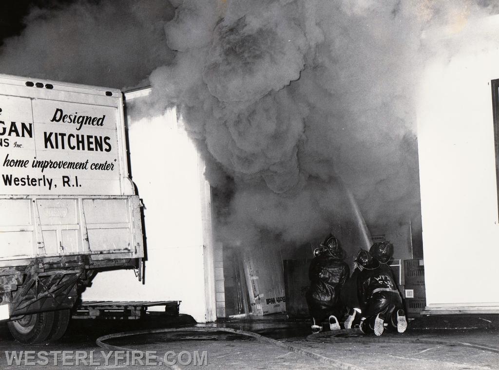 Box 4111-June 16, 1978-Vic Morgan & Sons Home Center 101 Canal St. Firefighters attack the fire from a large overhead door.