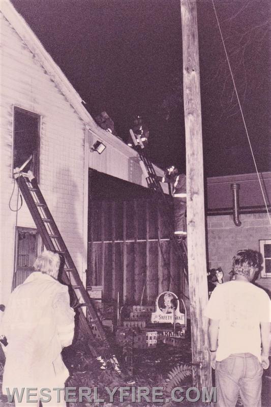 Box 1123-7-17-1994-117 Main St.-The C-side after the fire was knocked down. Firefighters rip open the roof to complete extinguishment. 