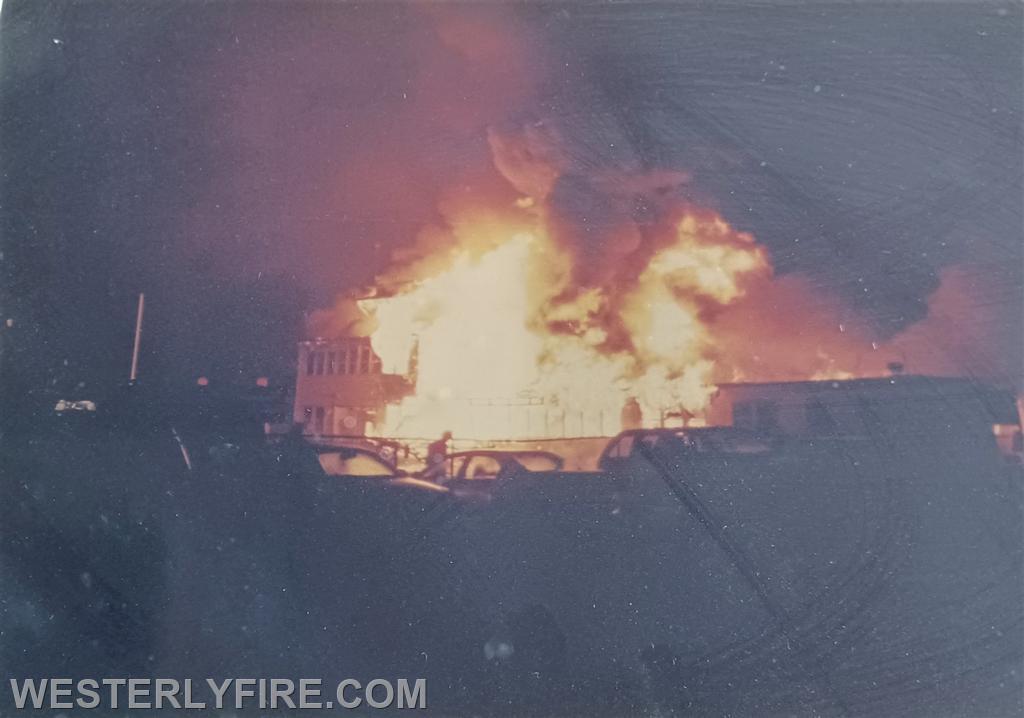 Box 1328-8-9-1998-Westerly Airport-Heavy fire showing from the center of the building as Engine 2 lays away from the hydrant near the A/B corner.