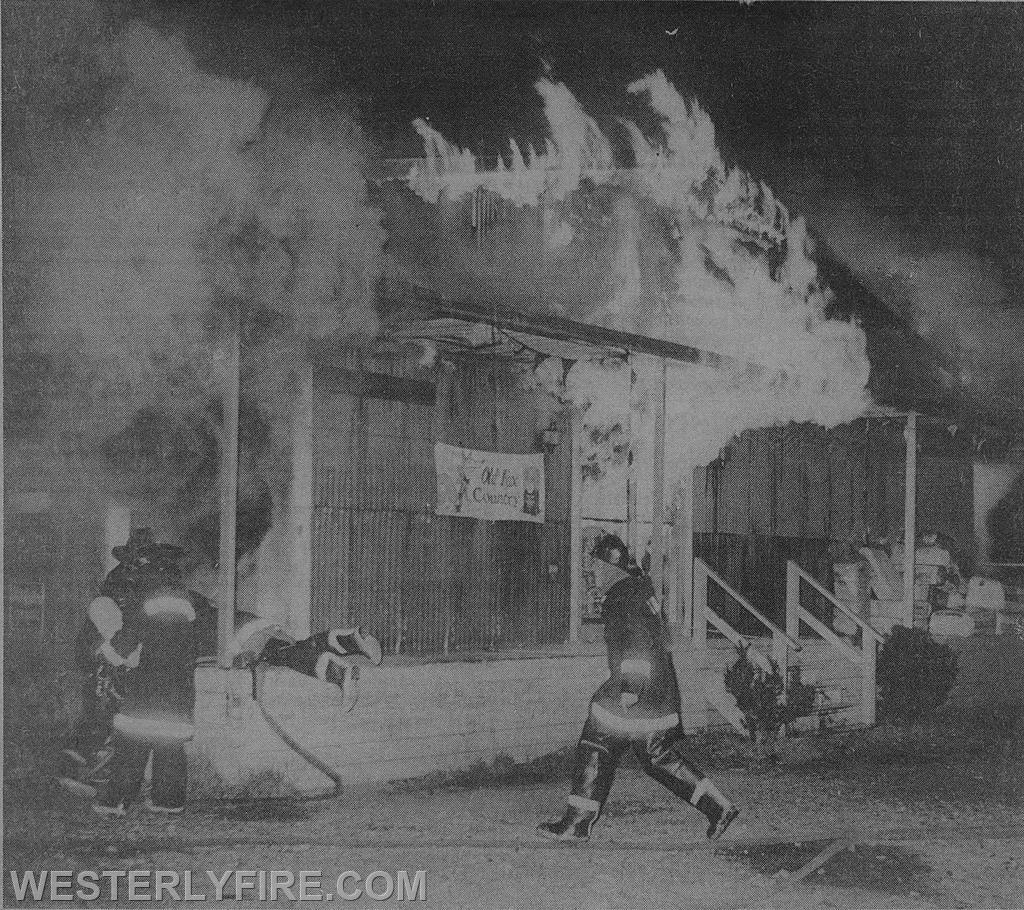 Box 3124-9-14-1975-Arriving firefighters find heavy fire showing from the front of the Westerly Grain & Supply Co.