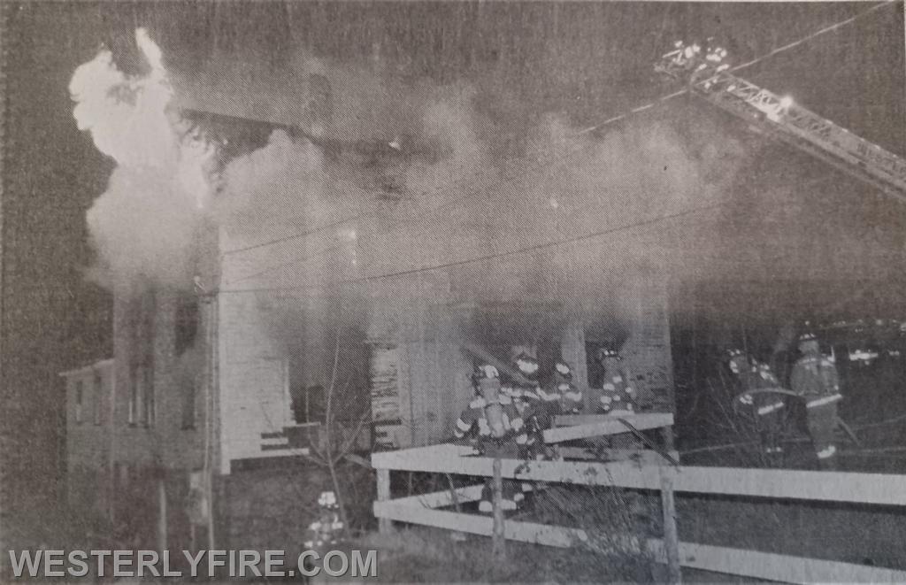 Box 3132-December 13, 1998-Heavy fire vents from the Charlie side of the house at 8 1/2 Park Ave as firefighters remove plywood and the aerial ladder moves into position.