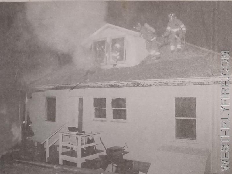 Box 3213-January 2,1999-Smoke billows from the second floor as firefighters work the roof at 8 Joshua St.