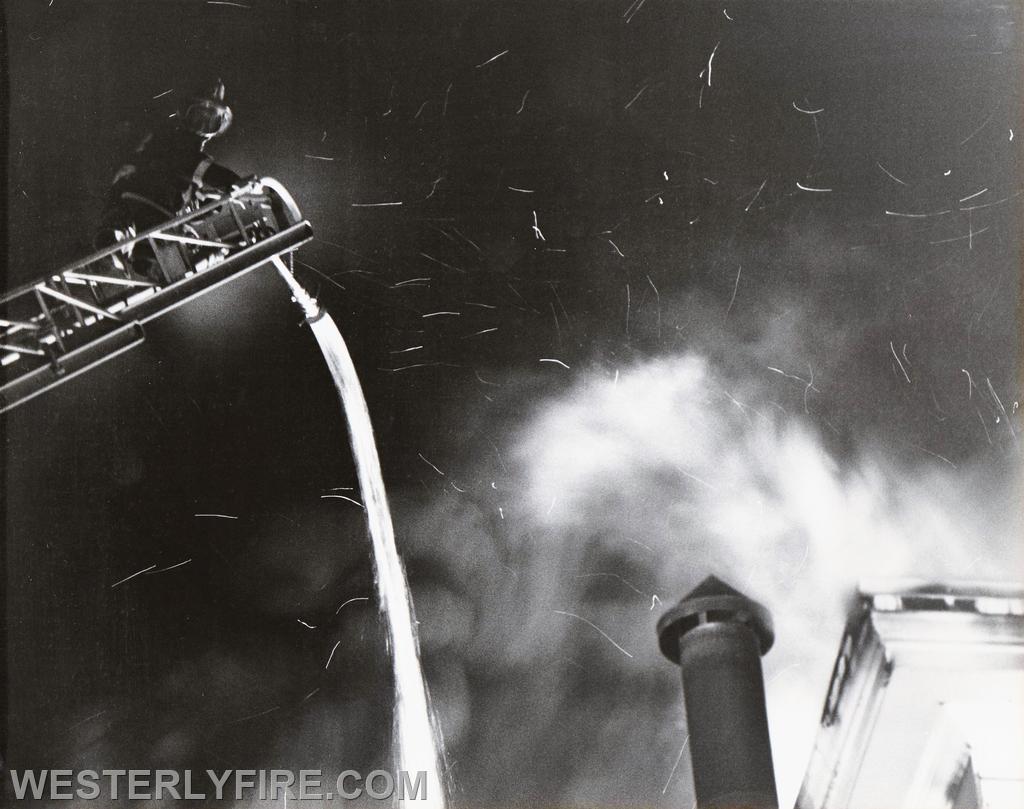 Box 534-March 26, 1978-Westerly firefighter looks down as water starts to flow from the ladder pipe.