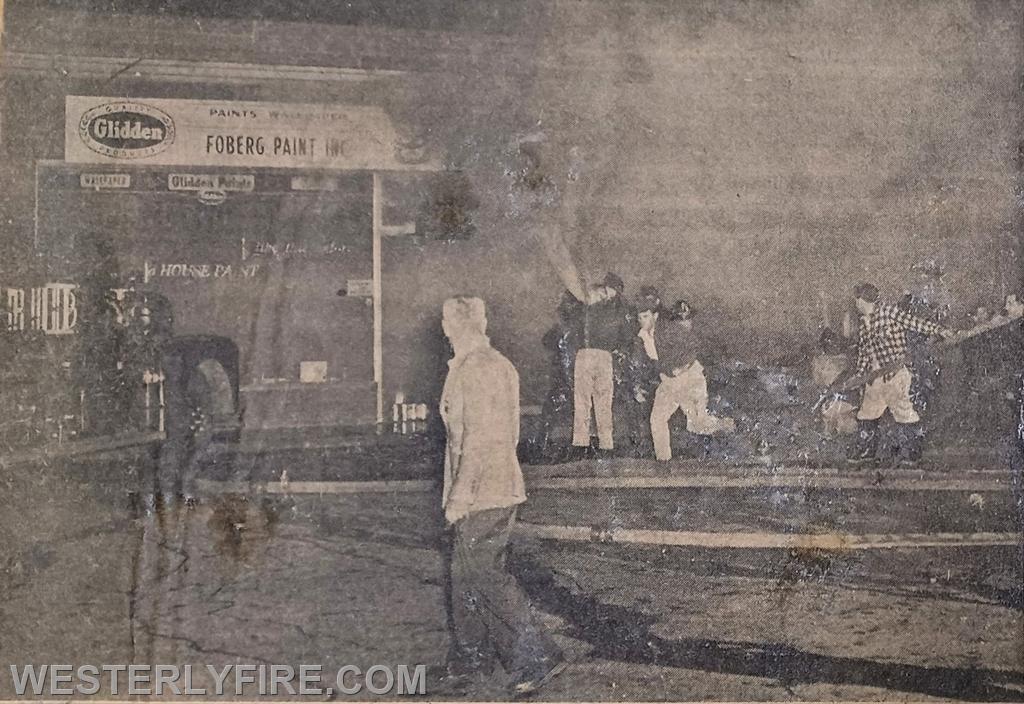 Box 1125-May 22, 1960-Westerly Firemen stretch multiple 2 1/2 inch hose lines in an attempt to control the fire in the Main St. Shopping Center.
